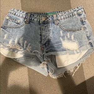 light wash jean shorts with rips. medium rise